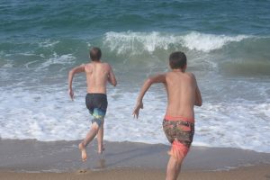 Boys running on beach